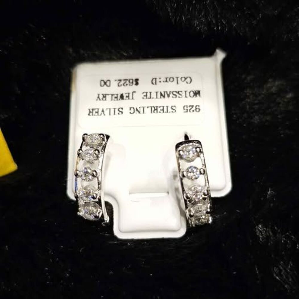. 3 CTW Moissanite huggie earrings set in .925 silver.